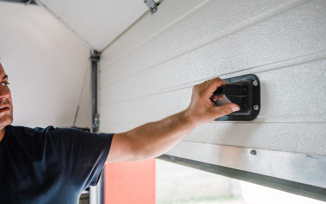 A man uses one of his garage door locks to secure the appliance.